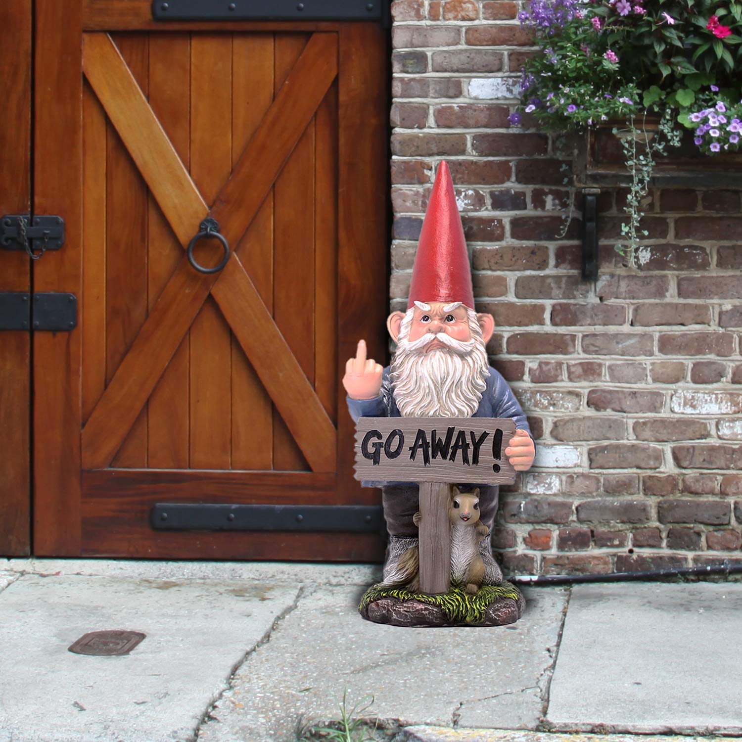 DWK garden gnome placed in flower bed showing playful outdoor accent