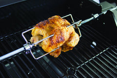 Dyna-Glo spit rod with two four-prong forks close-up showing secure hold