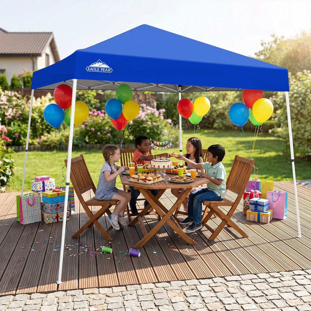 EAGLE PEAK canopy beside chairs illustrating true 10x10 base coverage