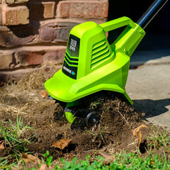 Earthwise battery and charger beside tiller for quick recharge convenience