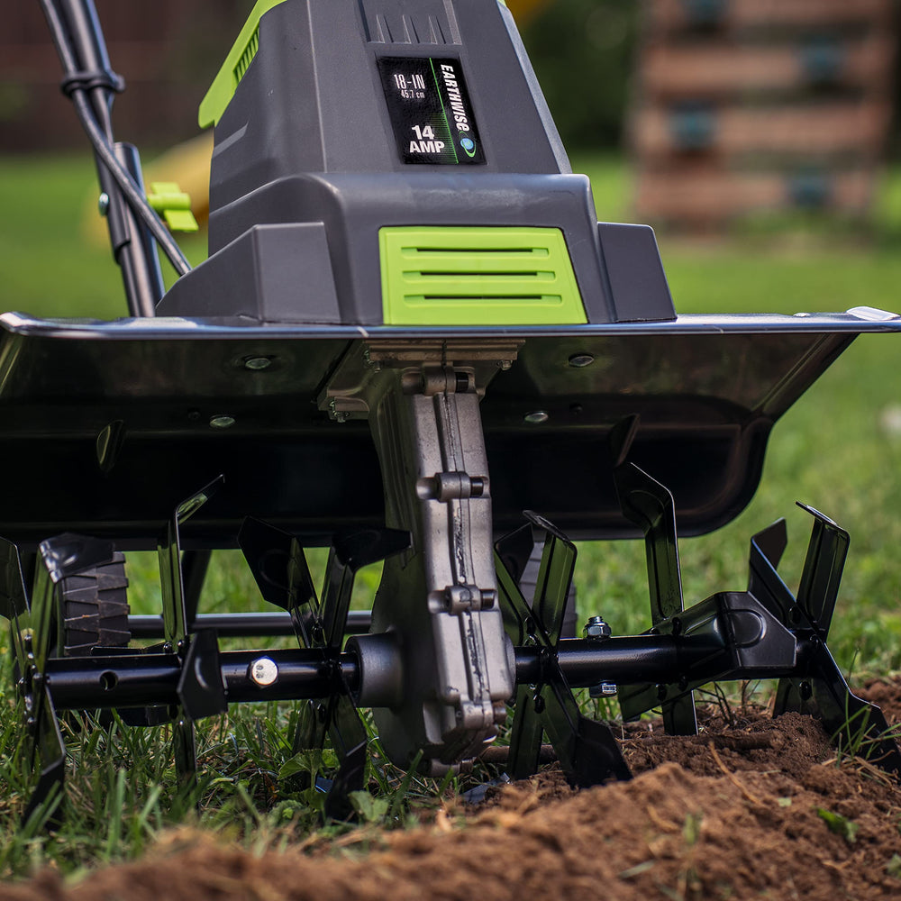 Earthwise tiller in use breaking up soil for faster bed preparation
