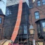 Easy Chute installed from roof to dumpster highlighting efficient debris funneling