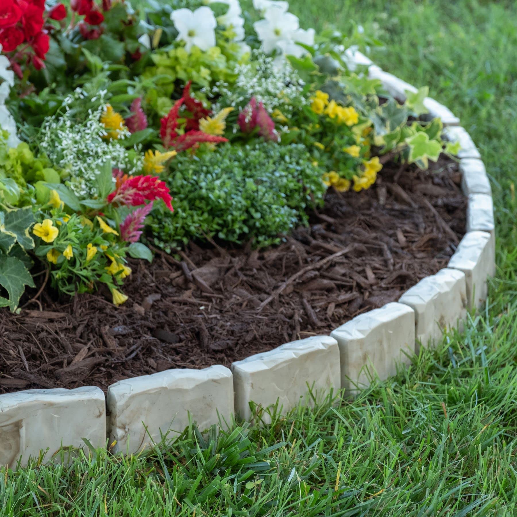 EasyFlex edging around a flower bed containing mulch and defining bed