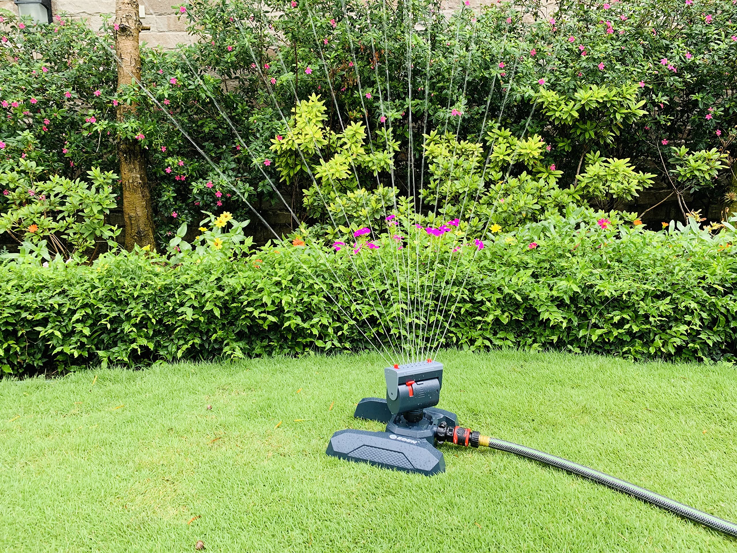 Eden sprinkler beside measuring tape illustrating coverage up to 4,069 sq ft