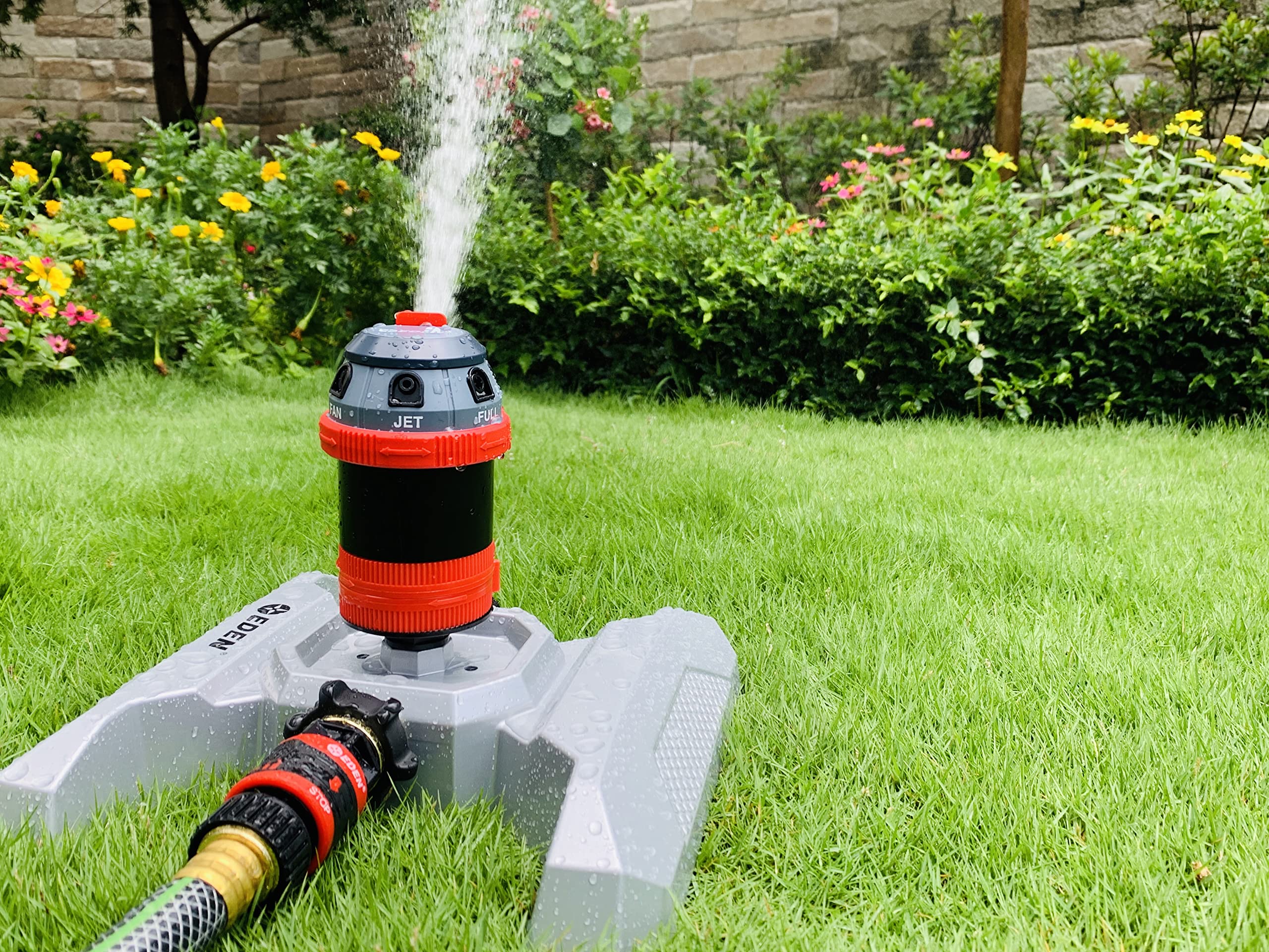 Eden sprinkler in use watering lawn and beds evenly to save time and water benefit