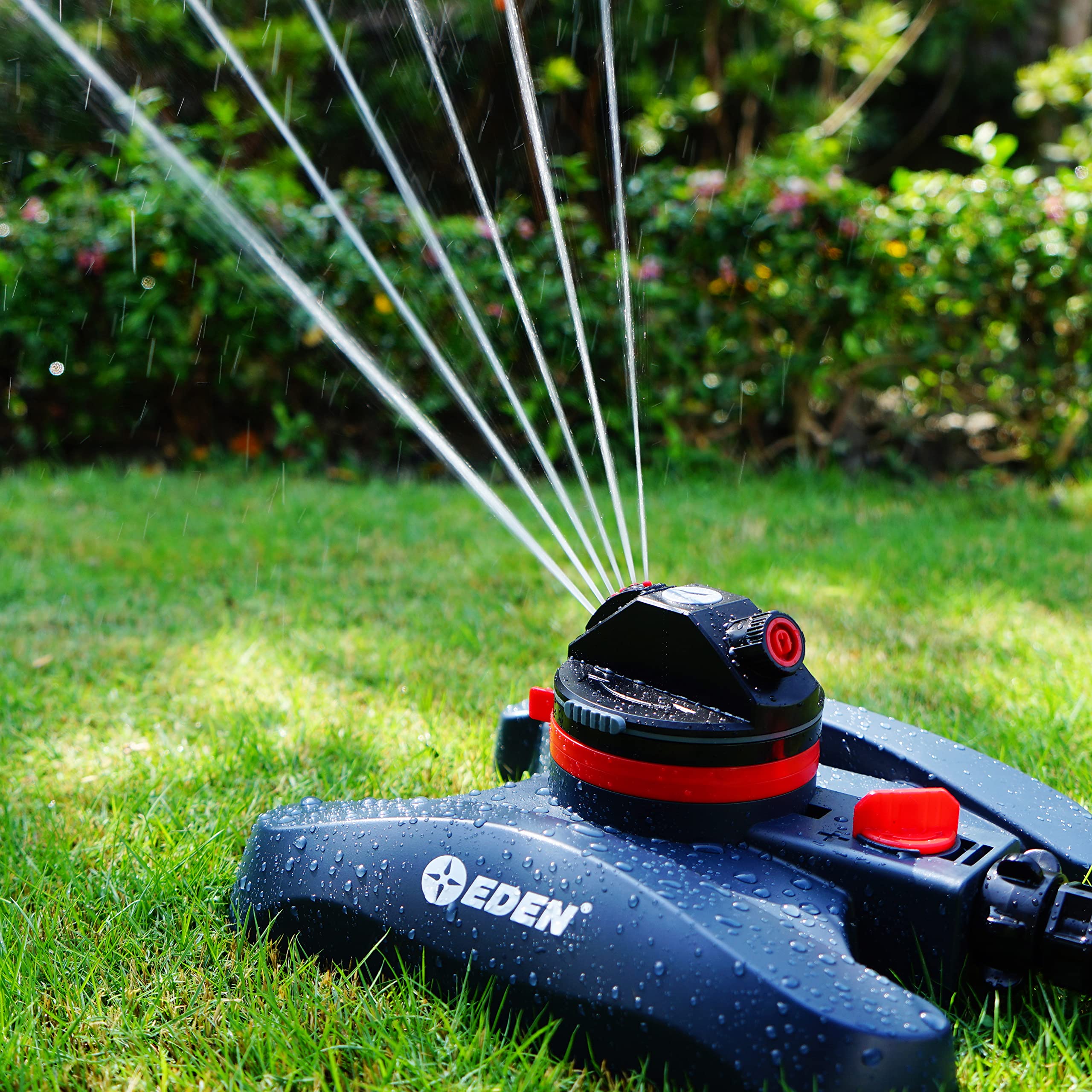 Eden sprinkler held next to hand showing scale and portability benefit
