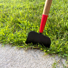 Emsco Group Bigfoot in use on driveway breaking ice safely with cushioned D-grip