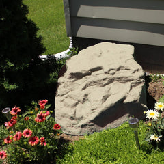 Emsco Group sandstone rock placed over sprinkler valve for discreet utility concealment