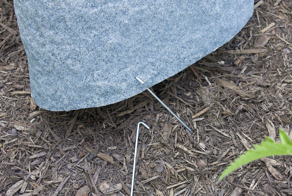 Emsco Group rock next to hand showing compact size and effortless one-person placement