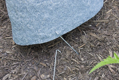 Emsco Group rock next to hand showing compact size and effortless one-person placement