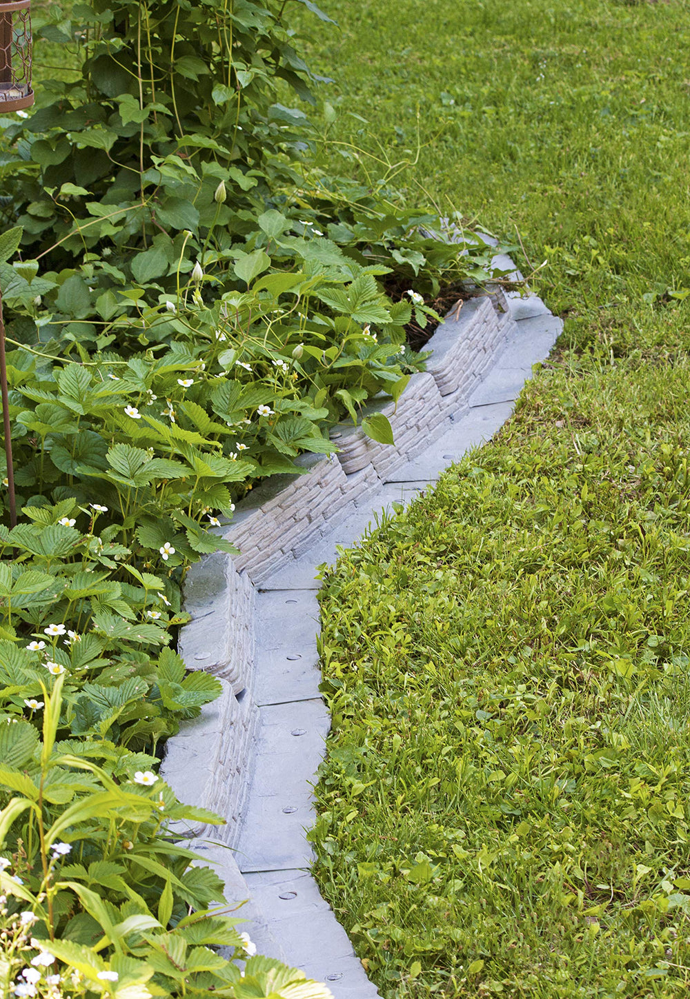 Emsco Group curved installation showing flexible edging following lawn contours for custom layouts