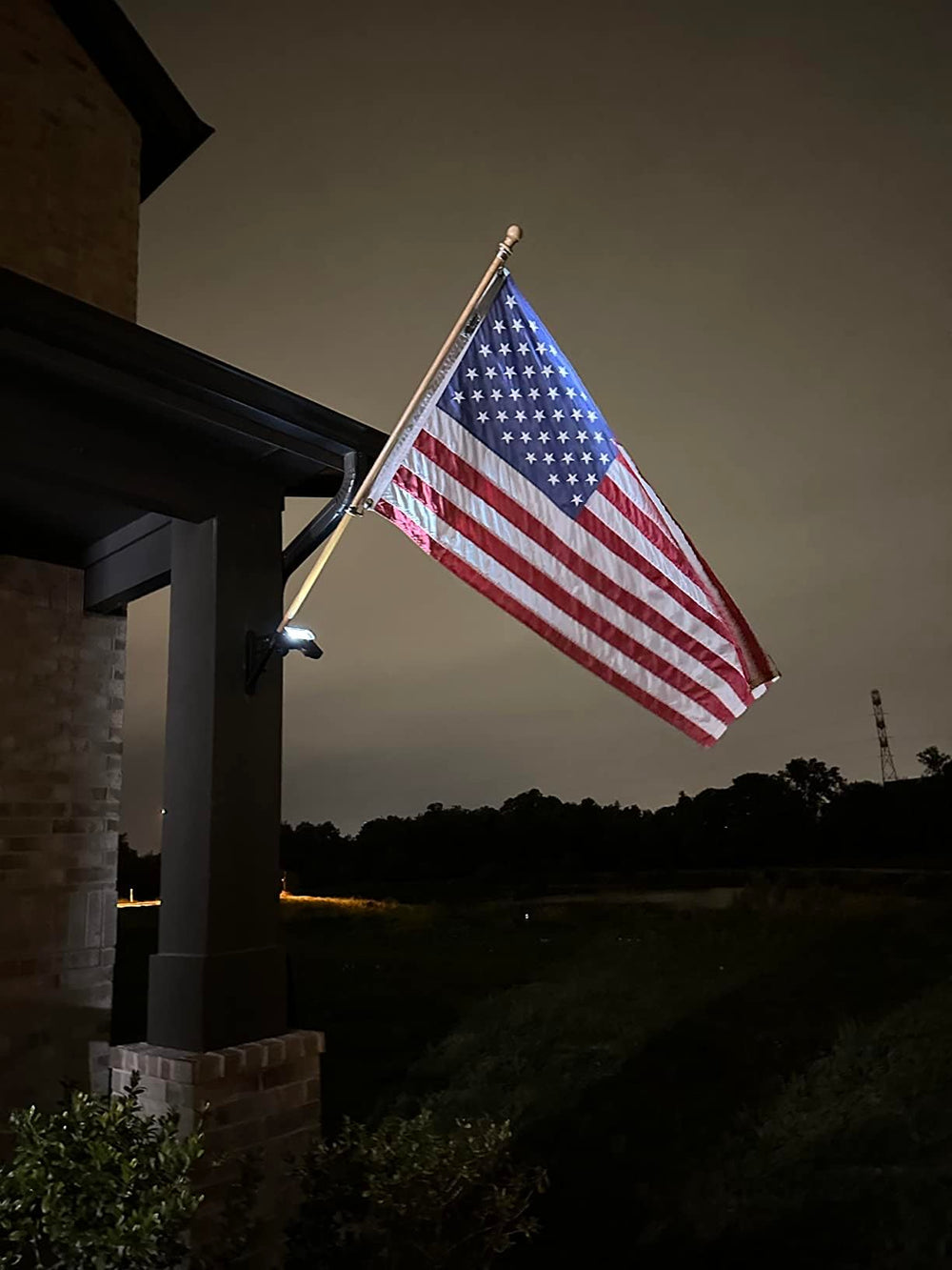 enrybia night view showing focused beam illuminating a flag clearly