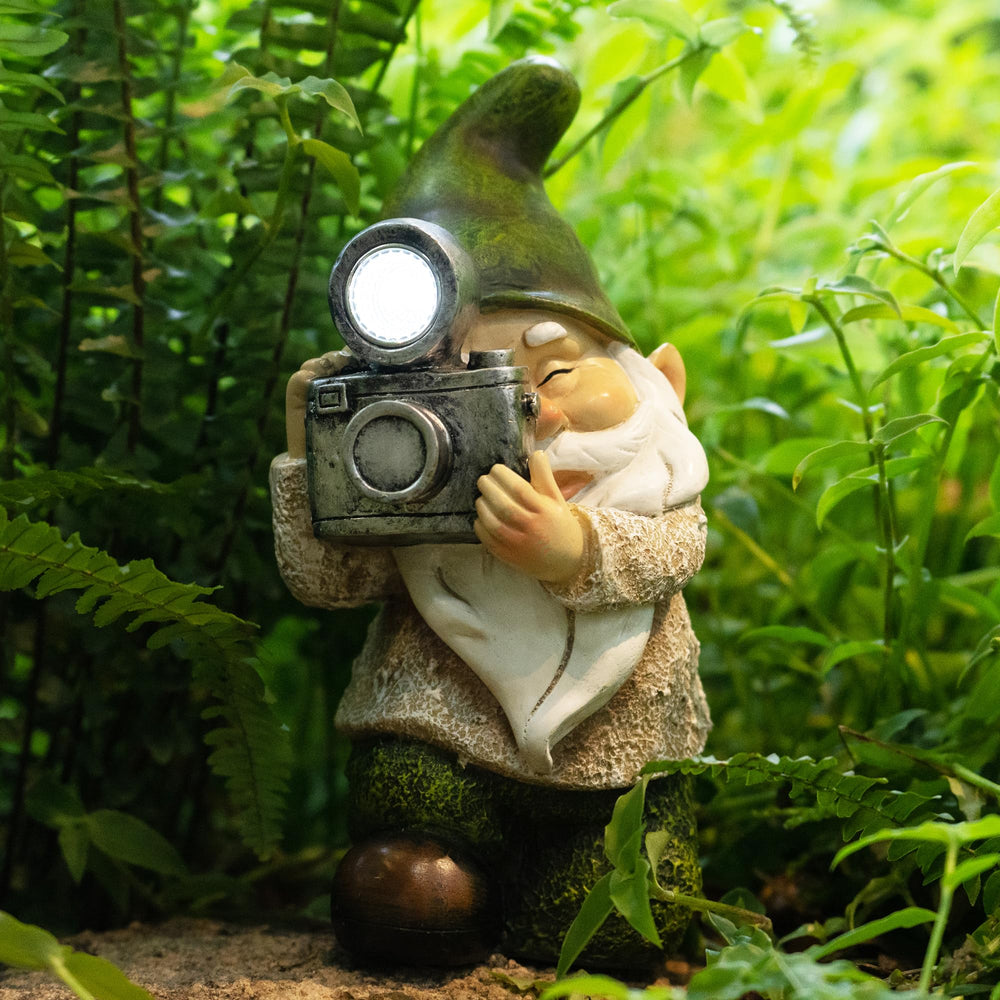 EPTUEGA gnome nestled in a flowerbed adding whimsical accent