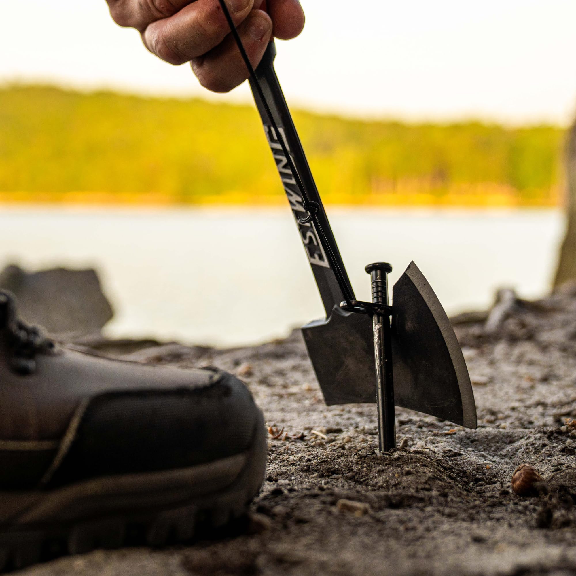 Estwing axe propped at a campsite fire pit showing portability and ready use