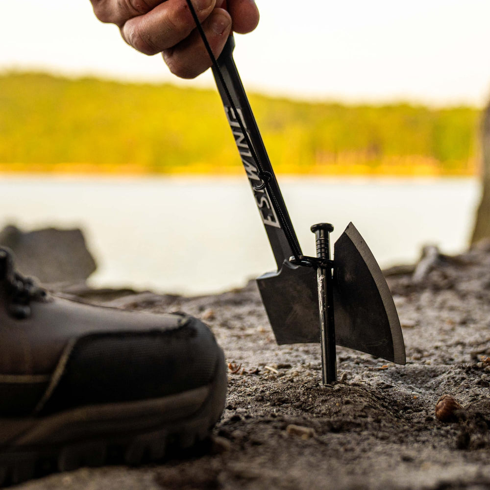 Estwing axe propped at a campsite fire pit showing portability and ready use