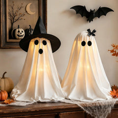 Eucehlre front view of light-up ghosts on mantel showing cozy ambiance