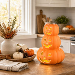 Evelyne close-up of three carved jack-o'-lantern faces highlighting playful detail
