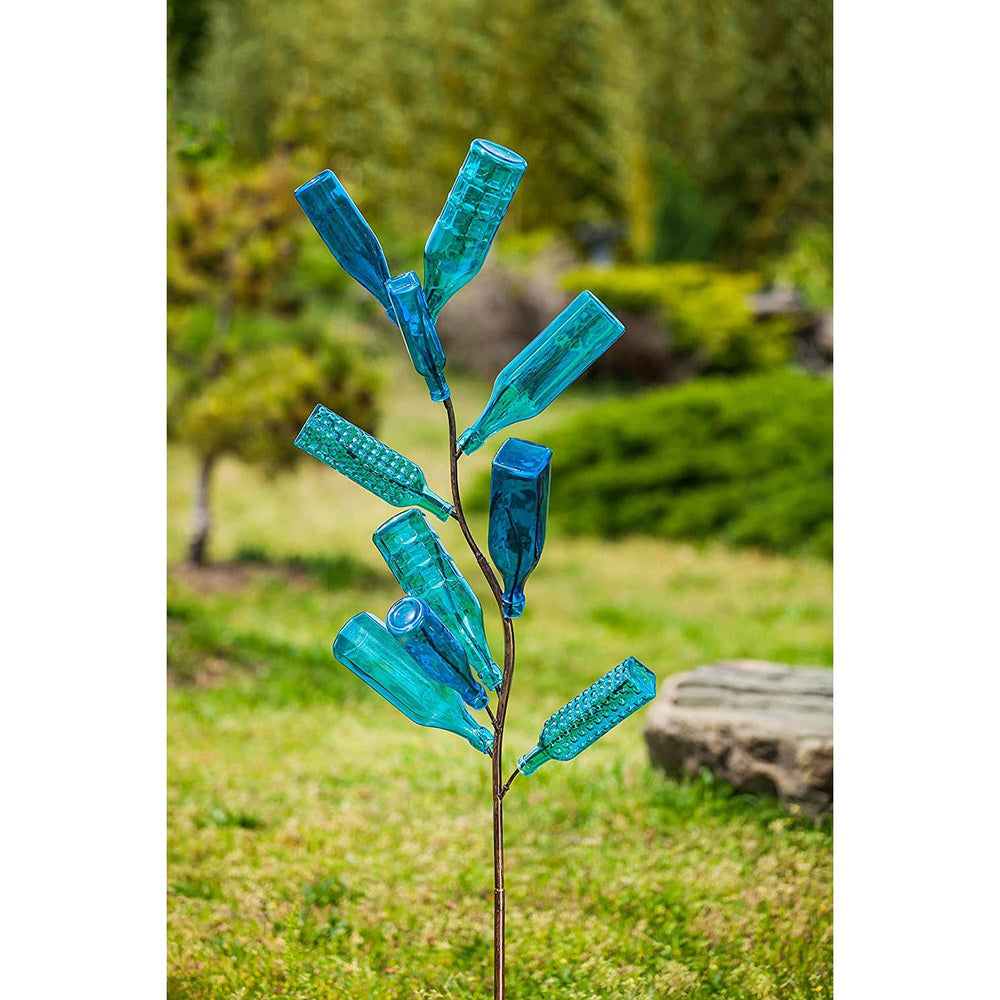 Evergreen Family Products staked bottle tree in garden demonstrating stable outdoor placement