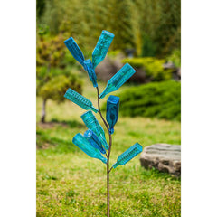 Evergreen Family Products staked bottle tree in garden demonstrating stable outdoor placement