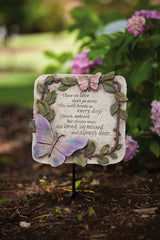 Evergreen Garden close-up of pink and purple butterfly detail and leaves enhancing tranquil tribute