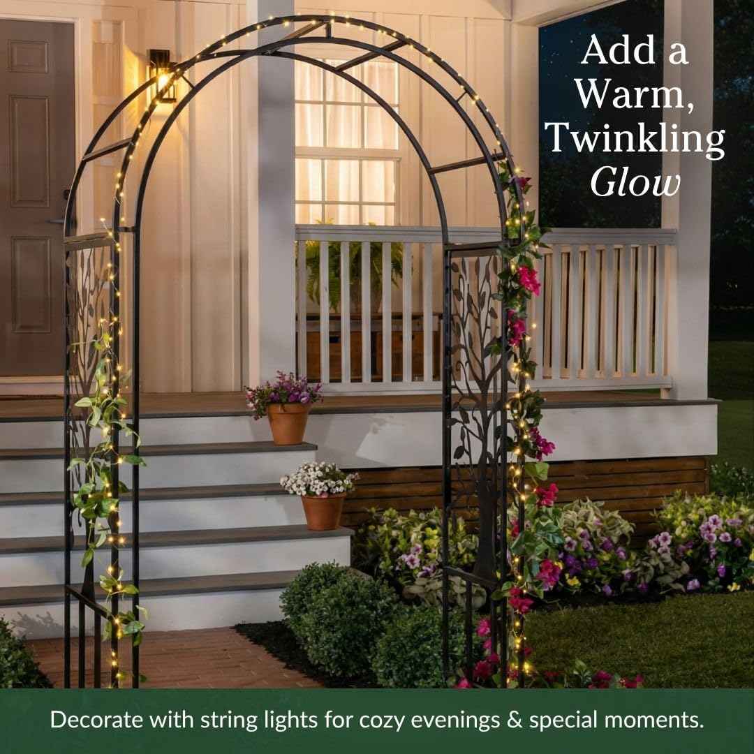 Evergreen Garden arch draped with string lights creates event-ready ambiance and glow