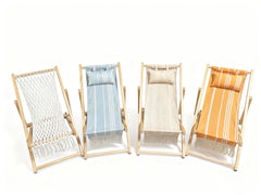 Evolve Heritage Collection child relaxing in sun lounger on beach demonstrating portable, kid-friendly outdoor comfort