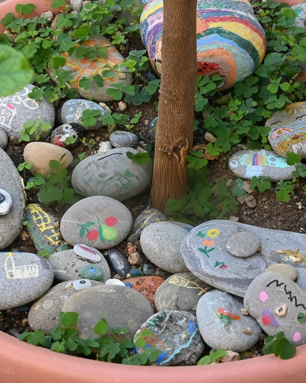 FAHAXIKI stones next to a hand showing 2–3 inch size for scale and safety
