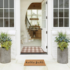 Fallovea dual layer porch styling with coir and plaid rug creating cozy curb appeal