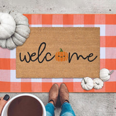 Fallovea detailed shot of orange and white plaid rug adding seasonal color
