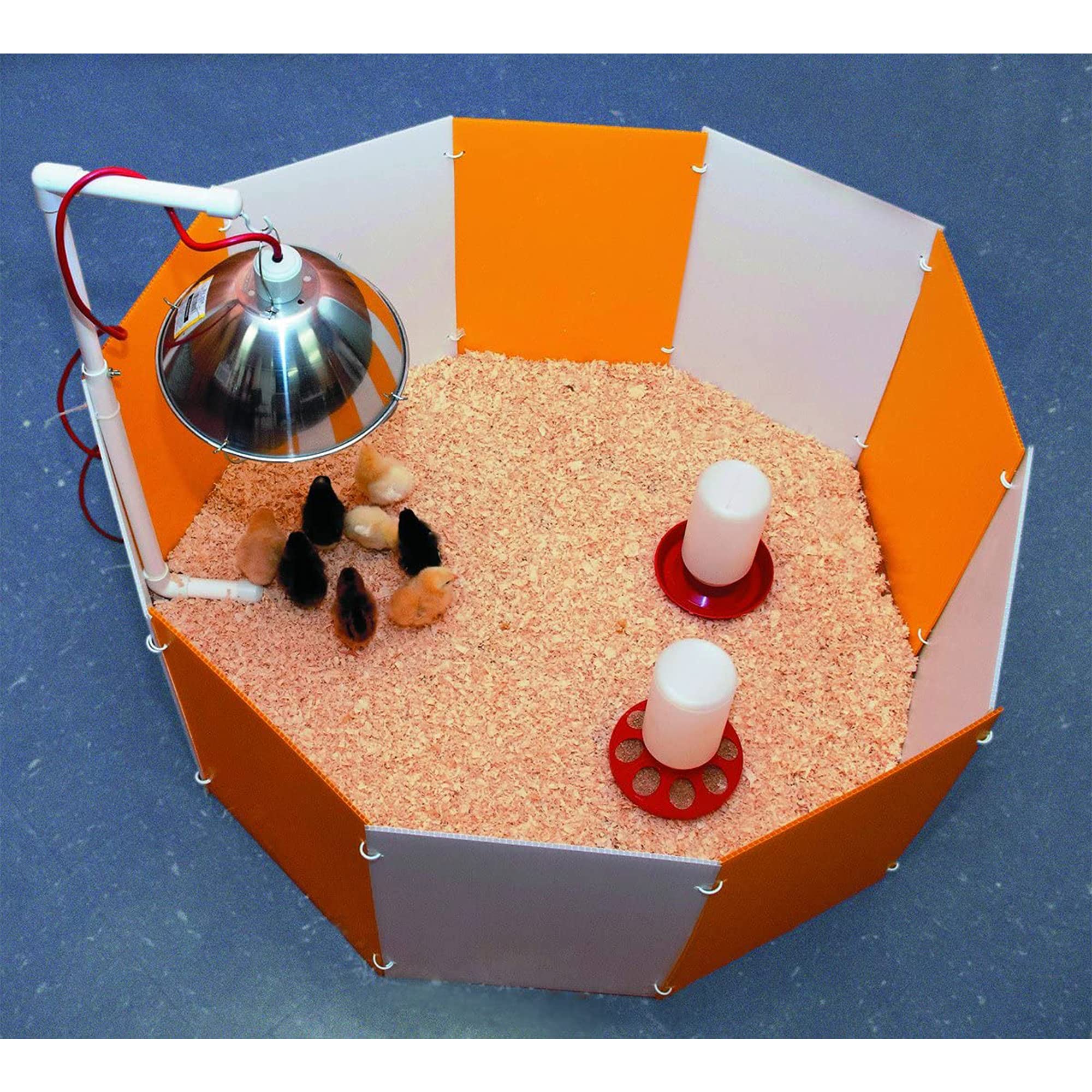 Farm Innovators corral next to a hand for scale to show 36-inch diameter size