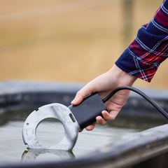 Farm Innovators C-500 submerged in plastic tub keeping water accessible for livestock