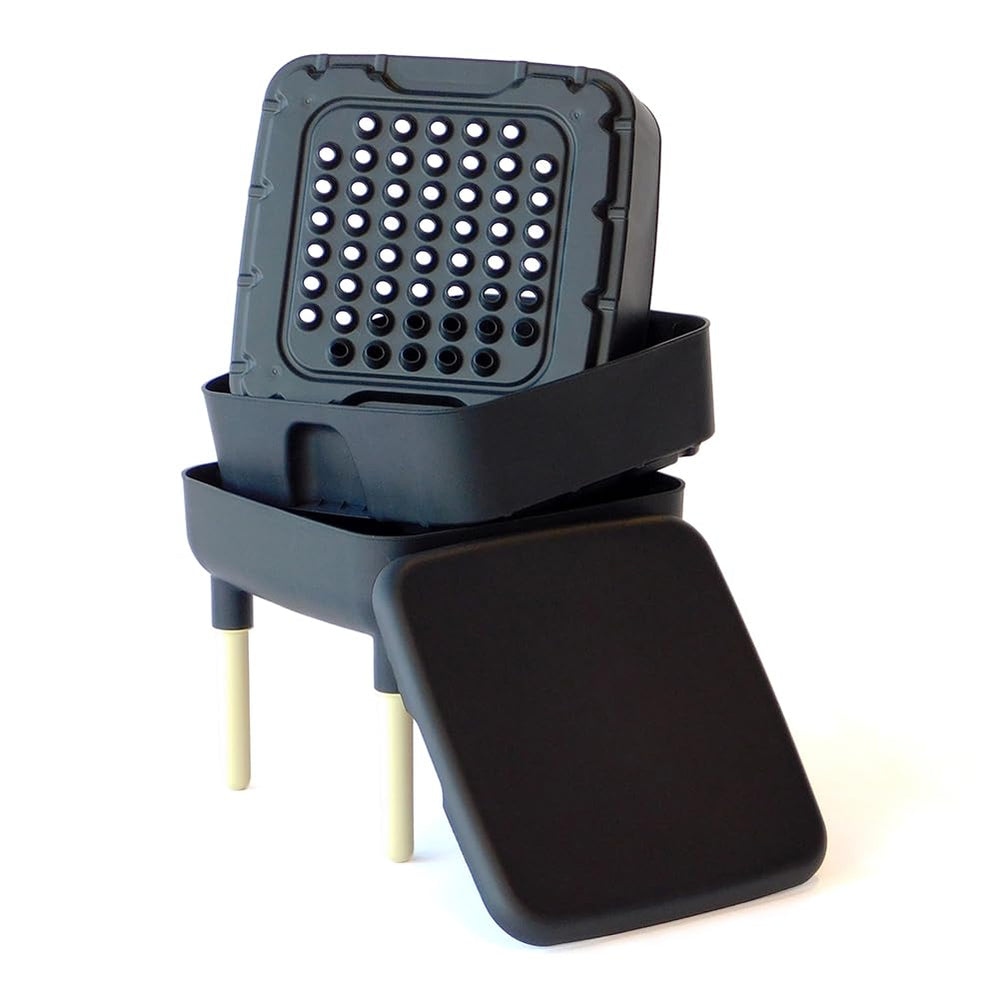 FCMP Outdoor composter next to hand and fruit showing compact size advantage