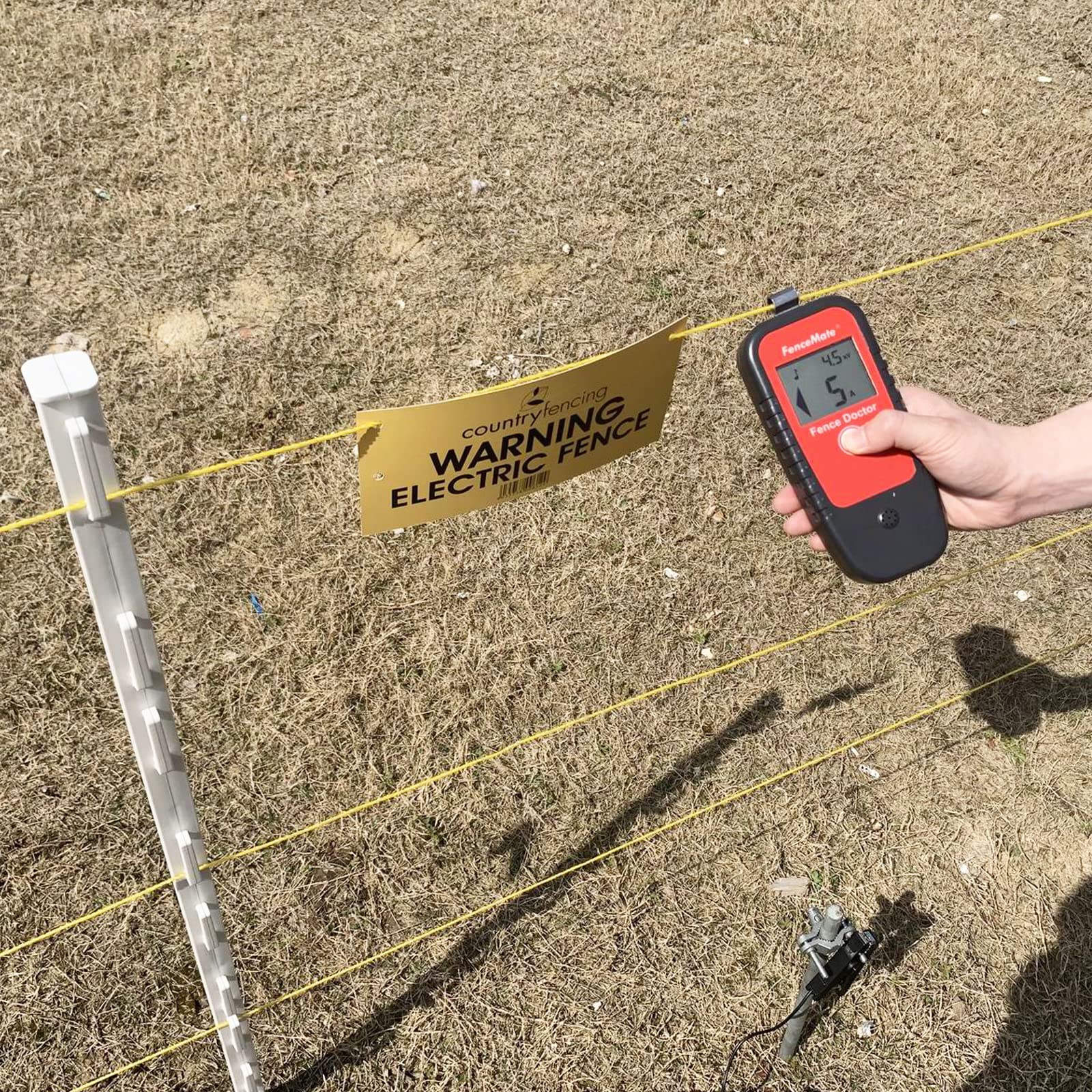 FenceMate next to included 9V battery for immediate field-ready power