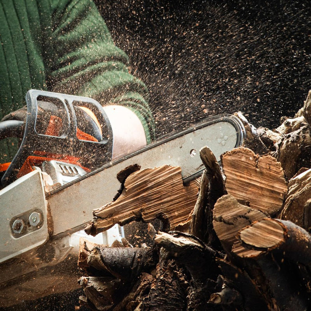 Fifchall bar and chain in yard setting cutting a limb demonstrating practical use