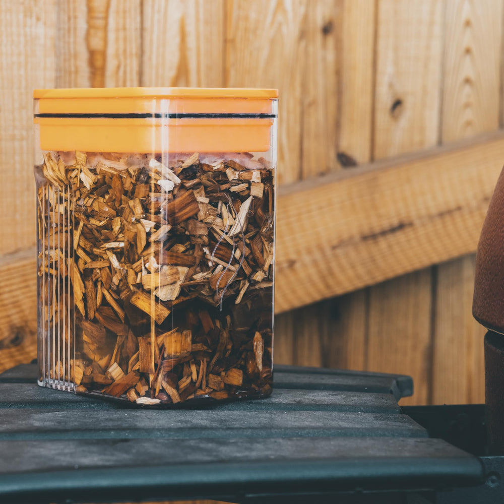 Fire & Flavor pack held in hand showing compact 2 lb size for convenient storage
