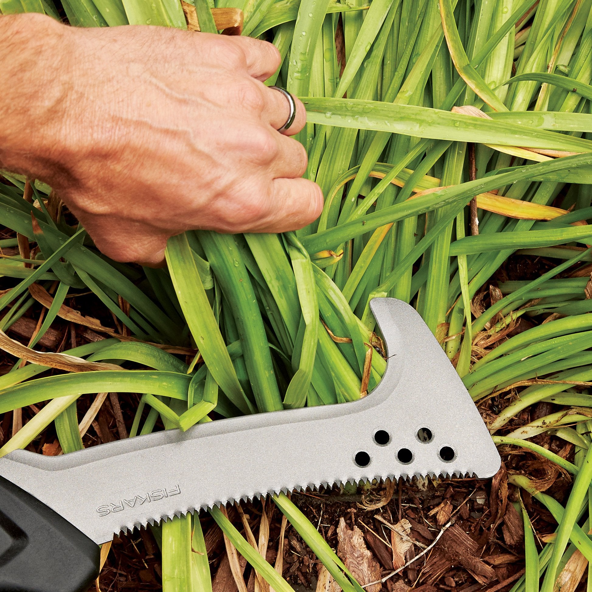 Fiskars saw powering through a woody branch showing coarse teeth effectiveness