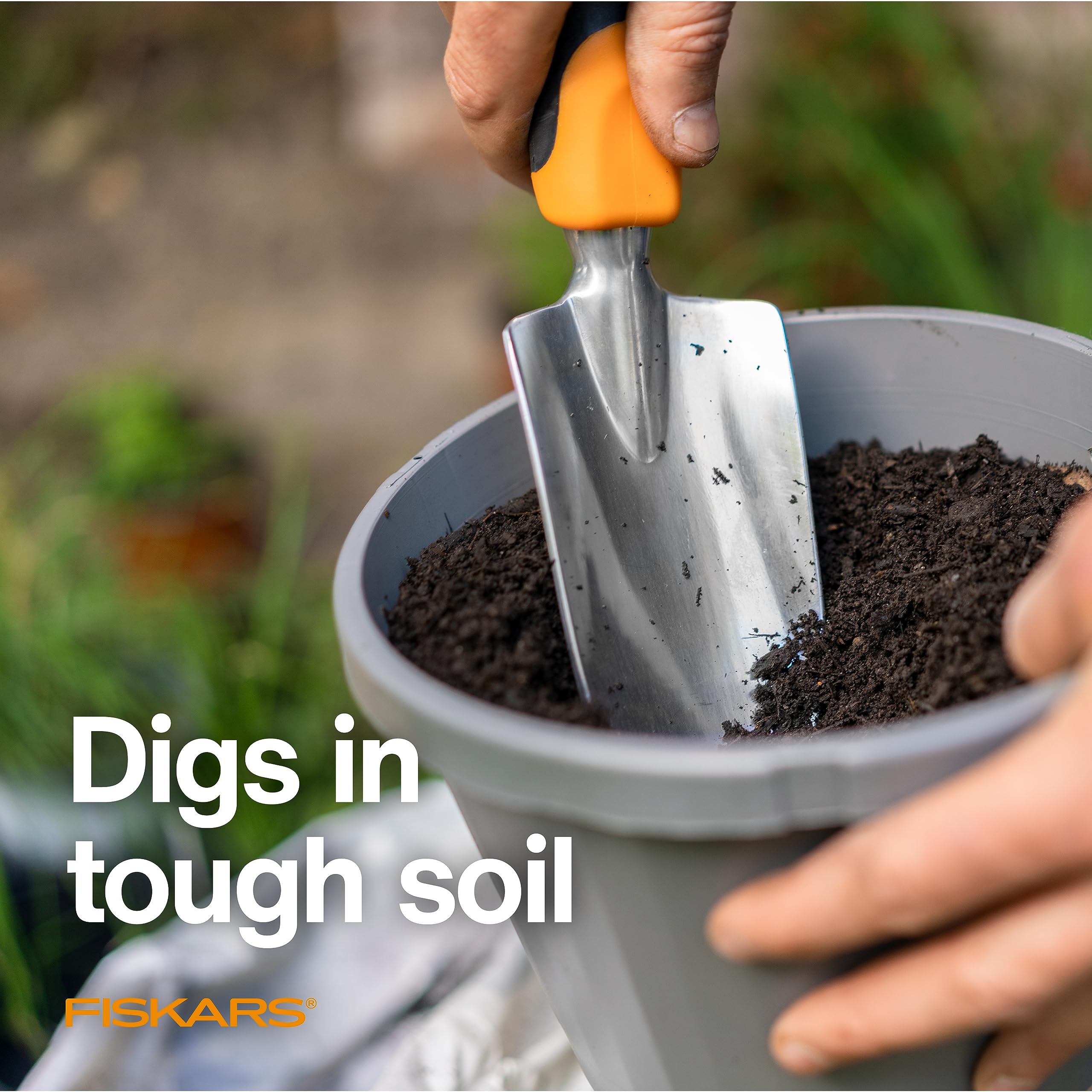 Fiskars trowel in use planting seedlings, demonstrating precise digging benefit