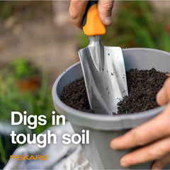 Fiskars trowel in use planting seedlings, demonstrating precise digging benefit
