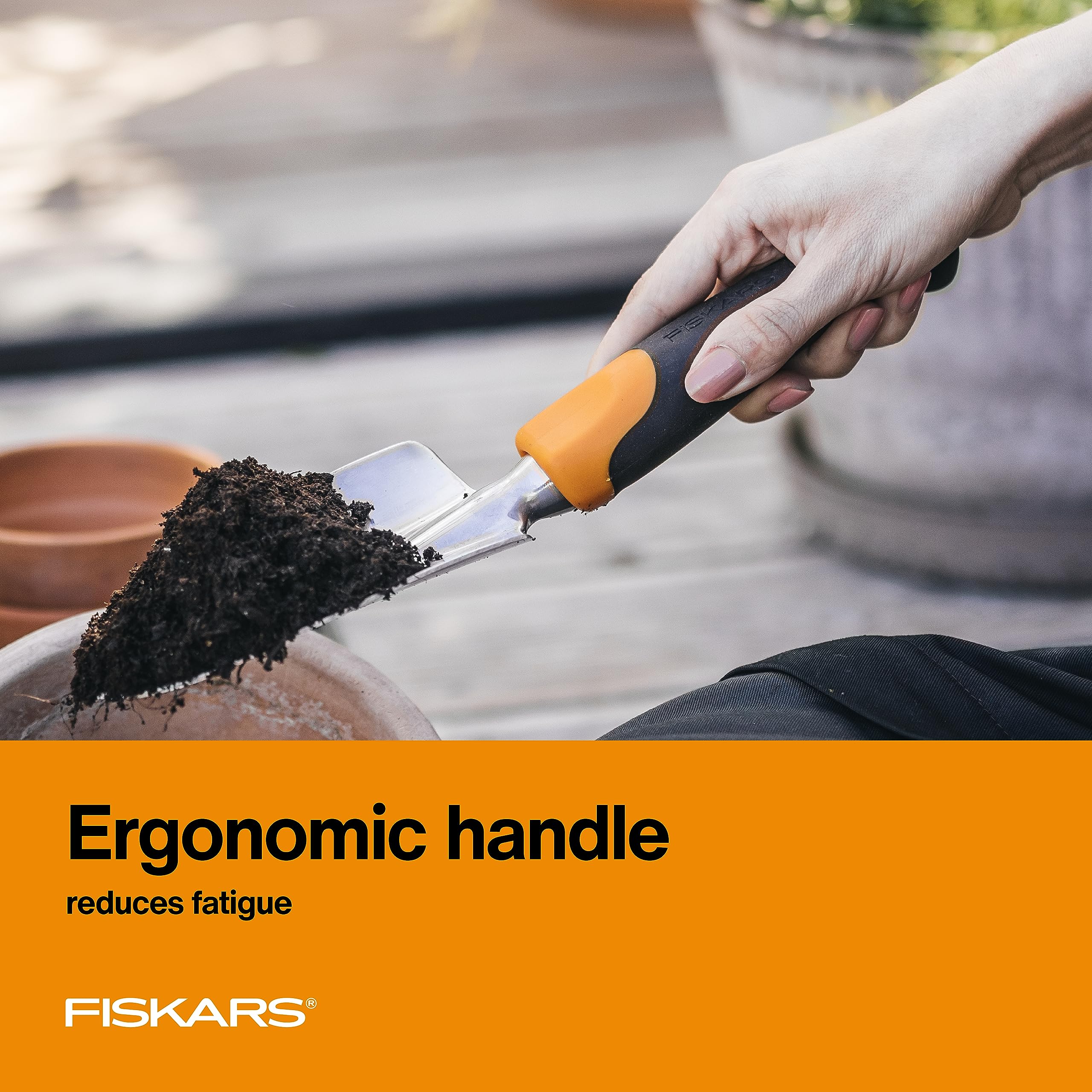 Fiskars trowel next to a hand for scale showing comfortable size and leverage
