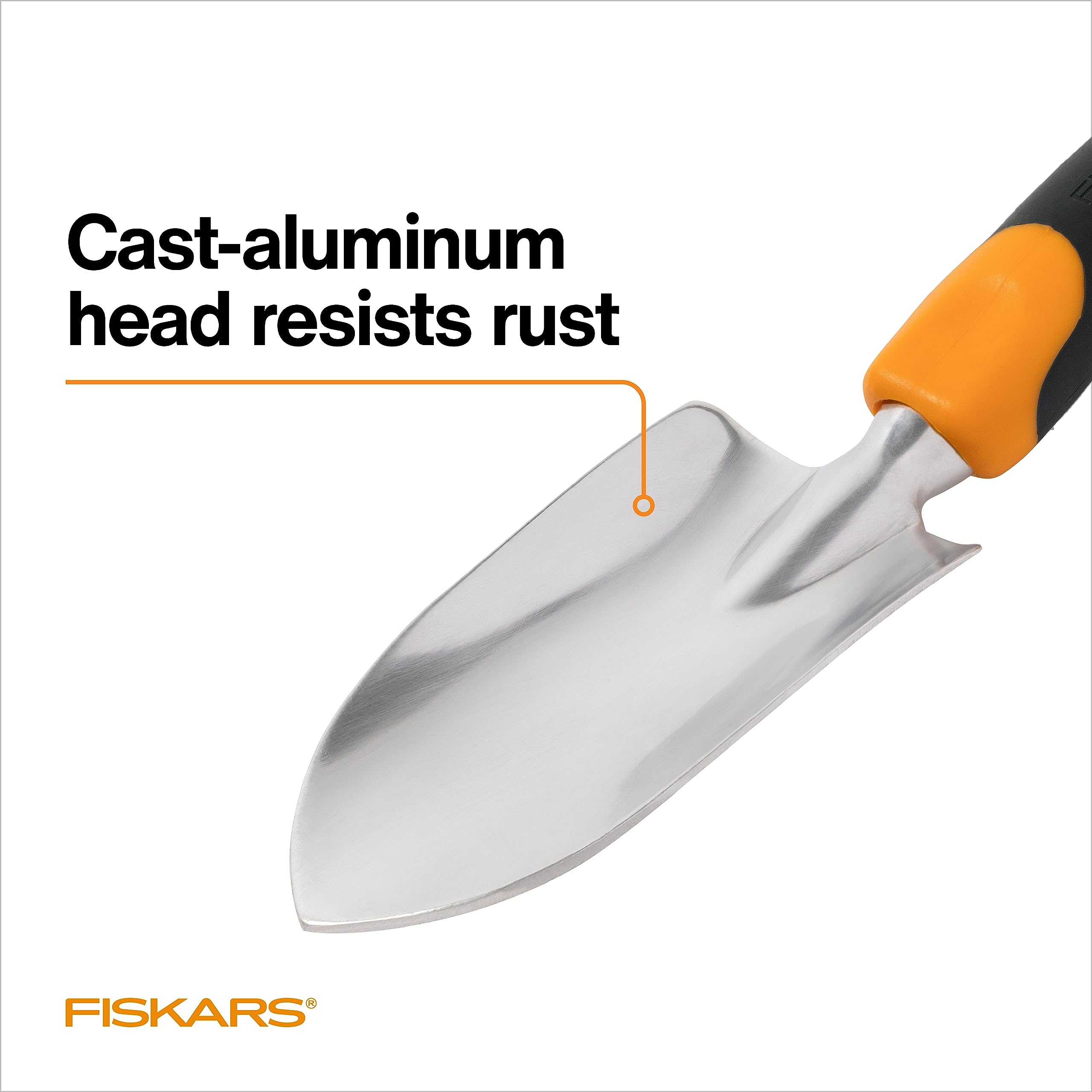 Side profile of Fiskars trowel scooping soil to show sharp scoop and efficient transfer