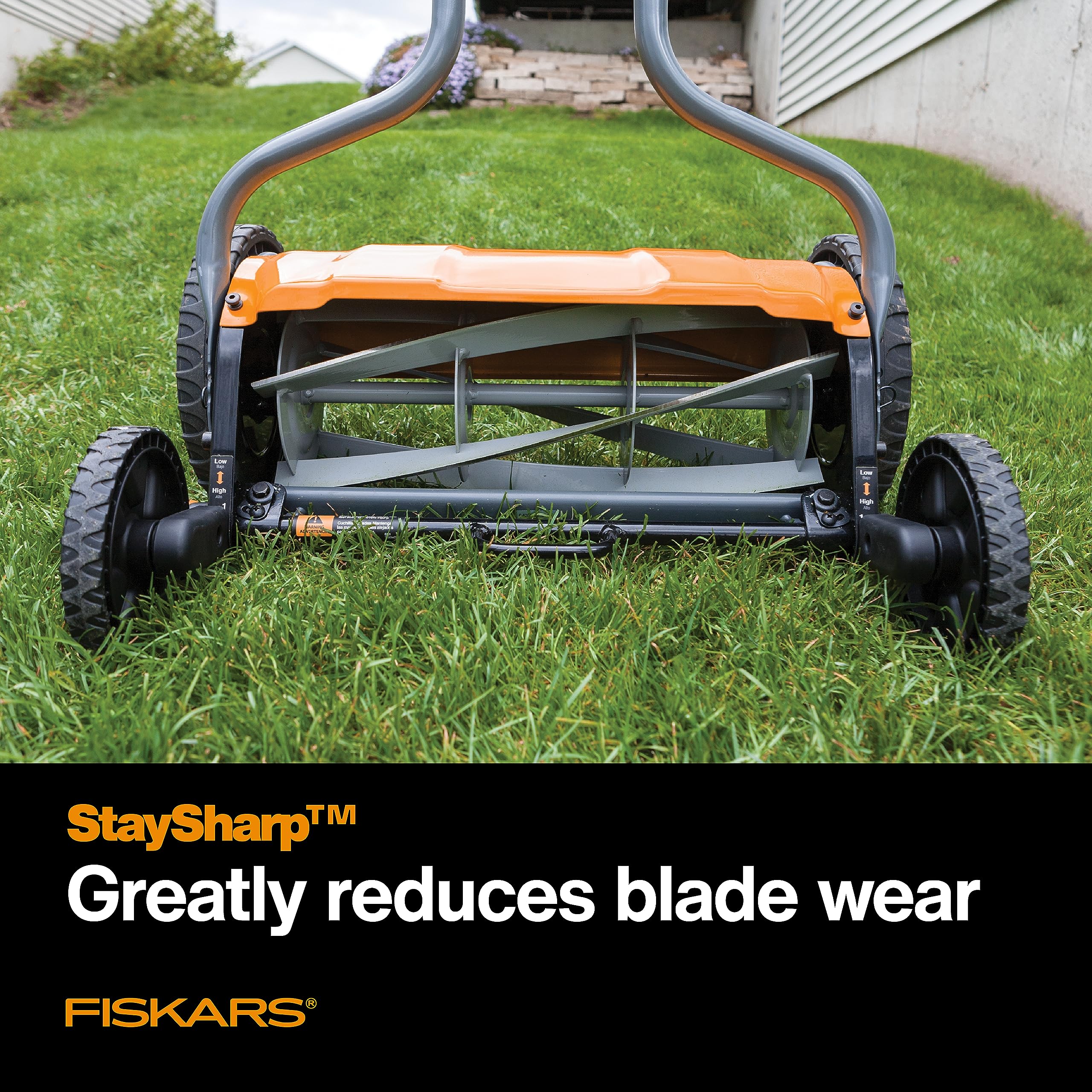 Fiskars reversible grass chute directing clippings away for tidy mowing and comfort