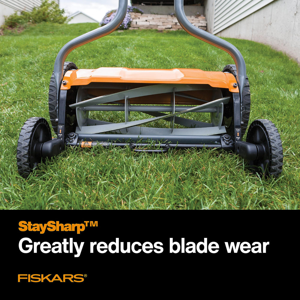 Fiskars reversible grass chute directing clippings away for tidy mowing and comfort