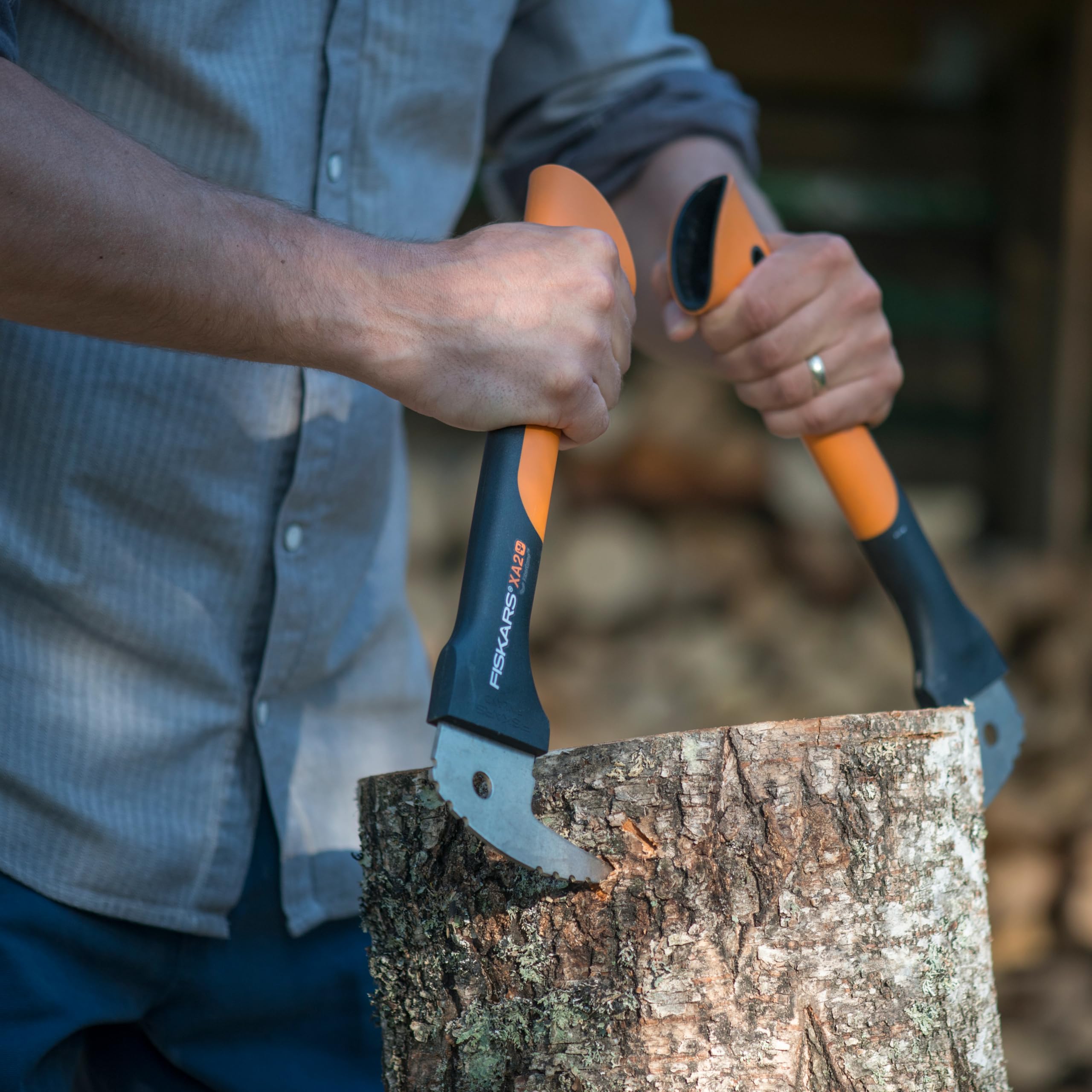 Fiskars Hookaroon next to a stacked backyard woodpile illustrating tidy results