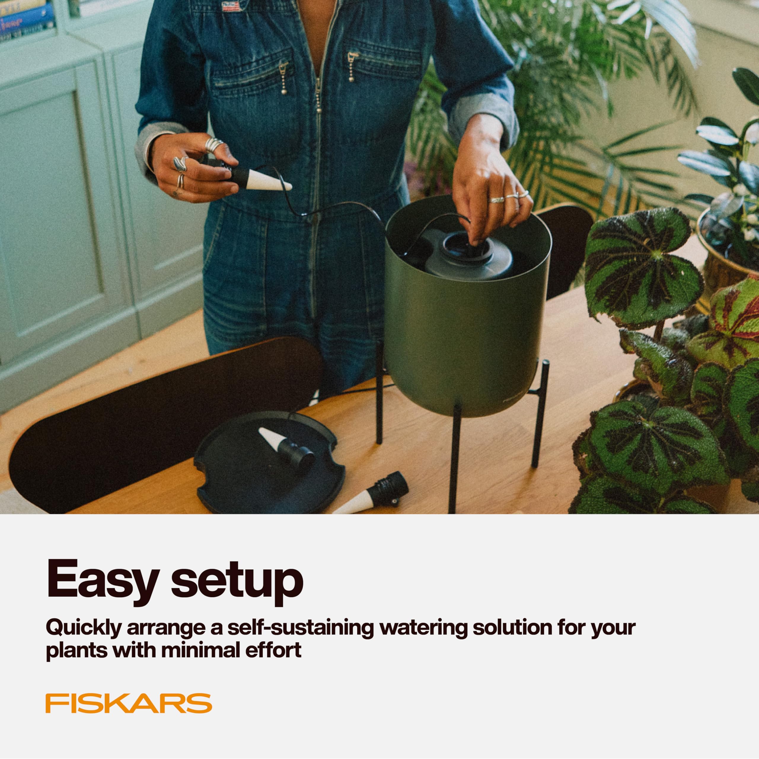 Fiskars hand holding the system showing compact size and easy placement benefit