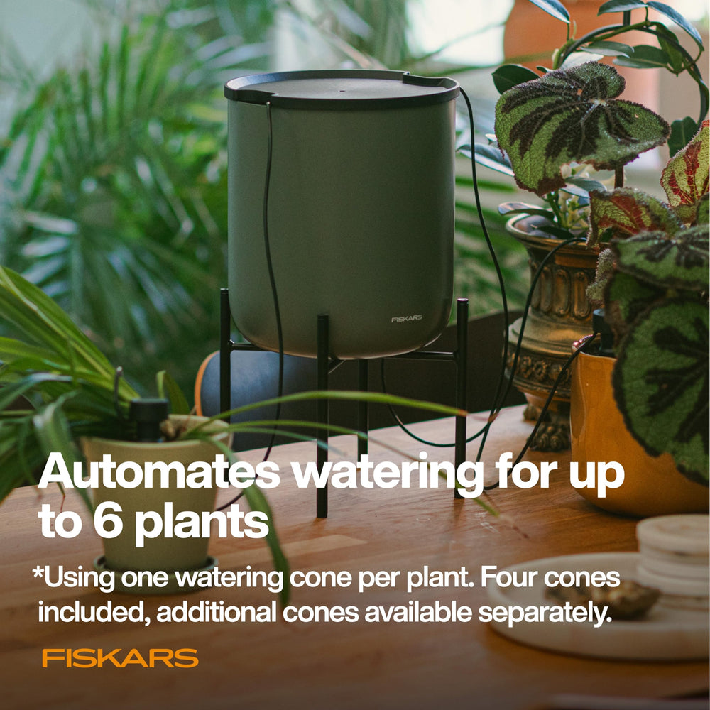 Fiskars stand supporting a potted plant showing dual-purpose jug and stand benefit