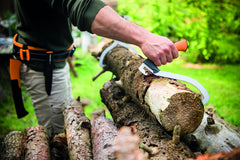 Fiskars log hook in use carrying a firewood log for safer hands-free movement