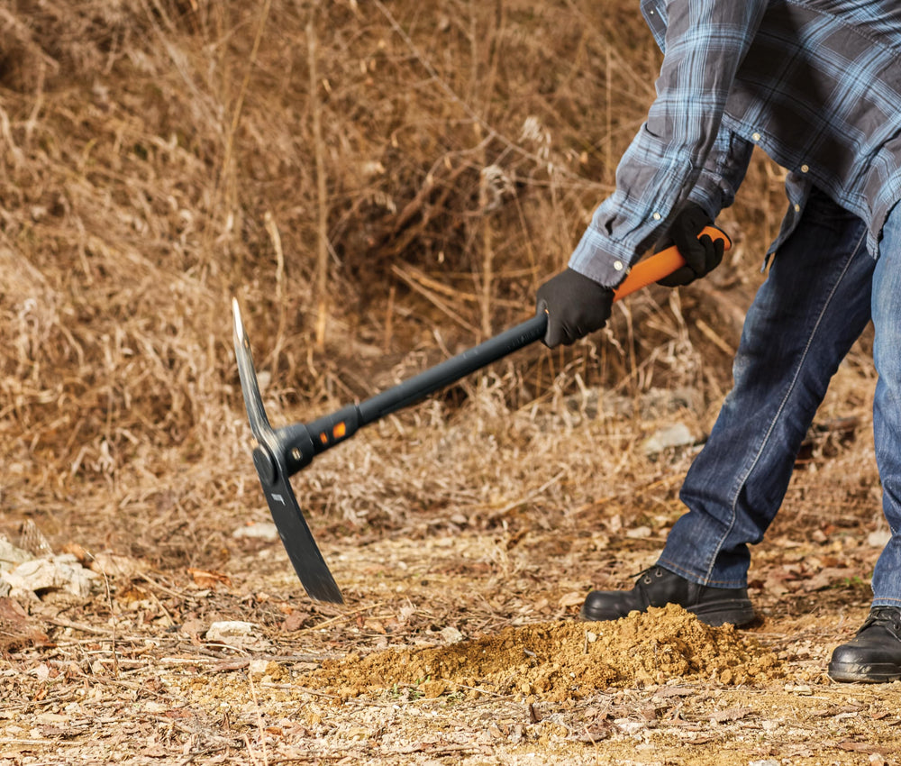Fiskars tool in use breaking compacted ground with less fatigue