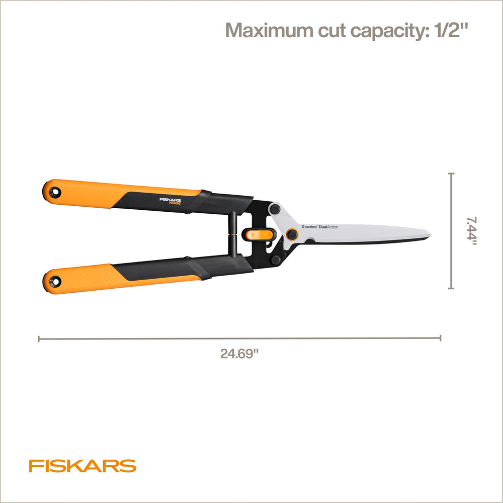 Fiskars shears beside hand showing 25-inch scale and leverage