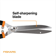 Fiskars shears cutting a hedge in use for fast, powerful trimming
