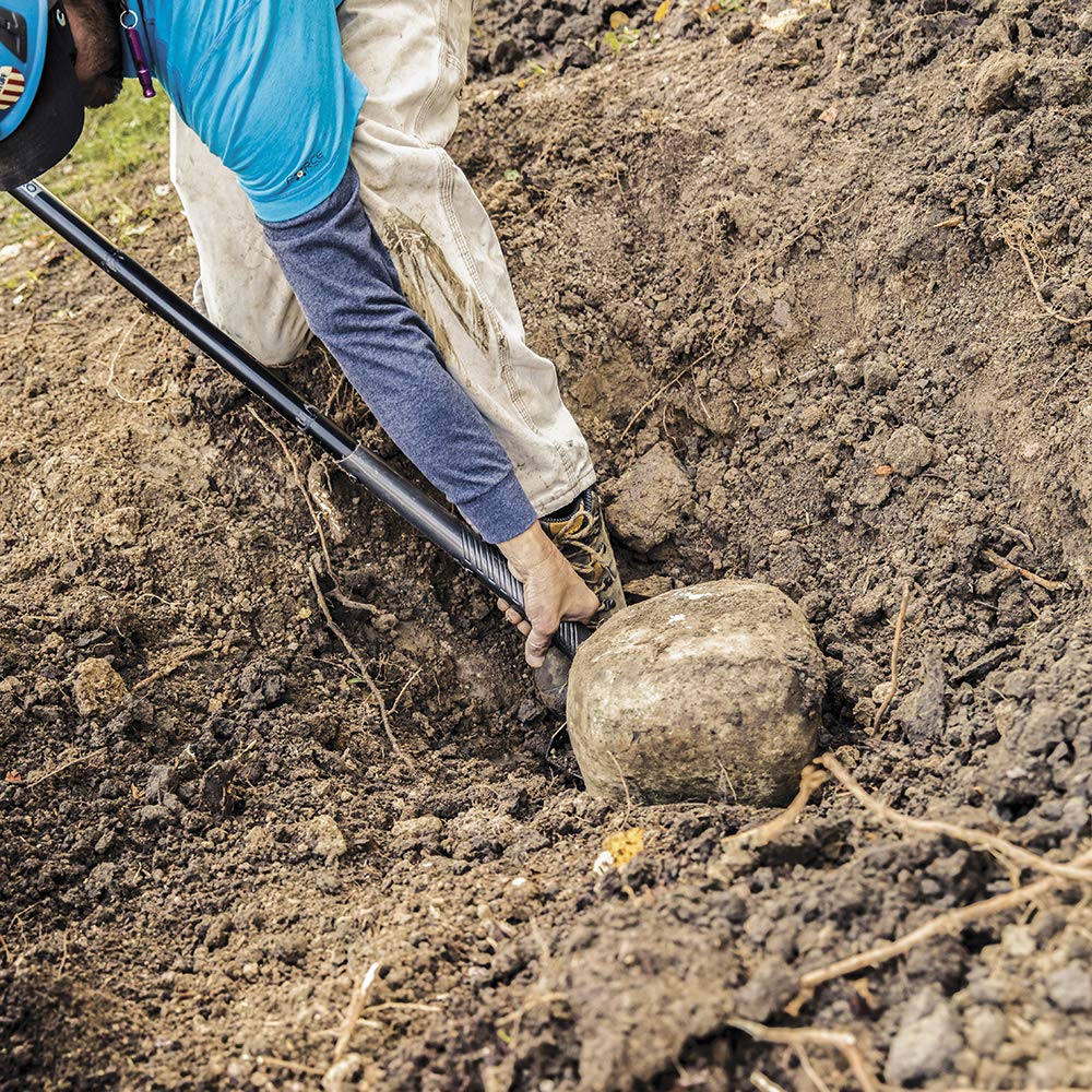 Fiskars shovel digging compact soil in garden demonstrating efficient digging